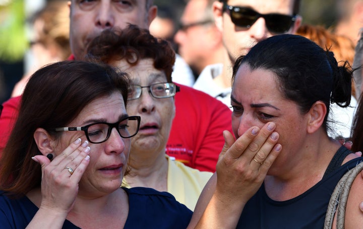 Mourners in Nice, France weep after a terrorist attacked a crowd of people celebrating a national holiday, killing
