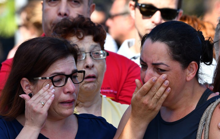 Mourners in Nice, France weep after a terrorist attacked a crowd of people celebrating a national holiday, killing and injuring many.