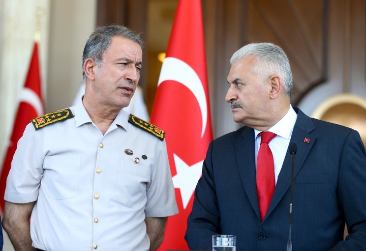 Turkish Prime Minister Binali Yildirim (R) speaks to media at Cankaya Palace with Chief of the General Staff of the Turkish Armed Forces, Hulusi Akar.