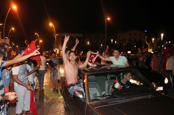 Supporters of Turkish President Tayyip Erdogan in the resort town of Marmaris celebrate after troops involved in the coup surrendered.