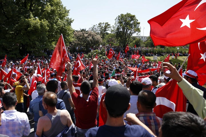 People gather outside parliament buildings in Ankara