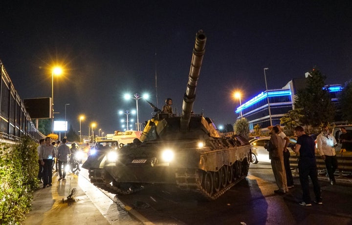 People gather near the Turkish army's tank near Ataturk Airport on July 16, 2016 in Istanbul, Turkey.