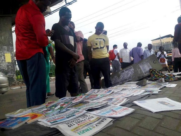 Lagosians reading newspaper