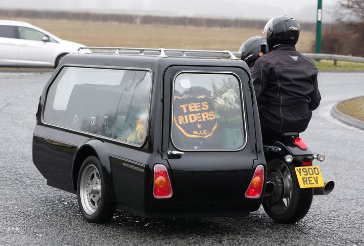 The coffin arrives at the funeral of Mick Collings, who died in the Didcot accident