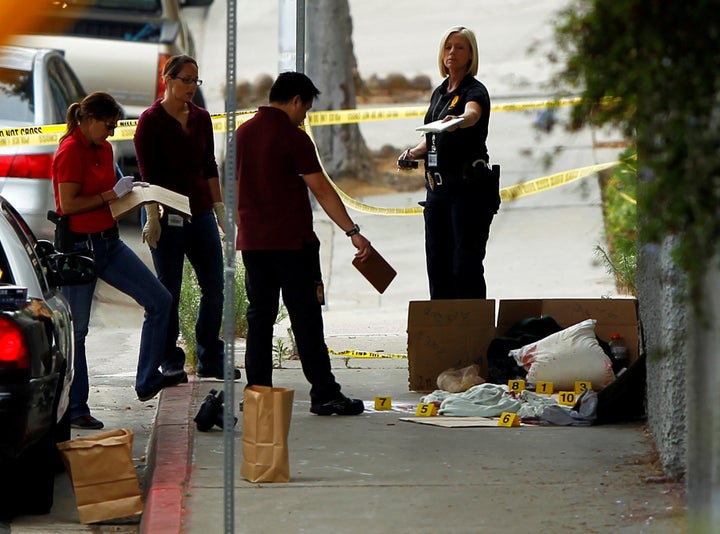 Police investigate Friday's scene under a San Diego highway overpass where another apparent attack by a serial killer targeting homeless men took place.