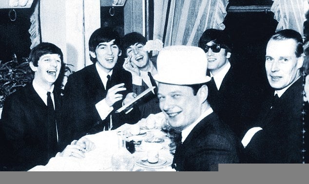 The Beatles with Brian Epstein (L, donning a chamber pot) and George Martin (R) in Paris in January 1964 on the night they learned "I Want to Hold Your Hand" had topped the American charts.