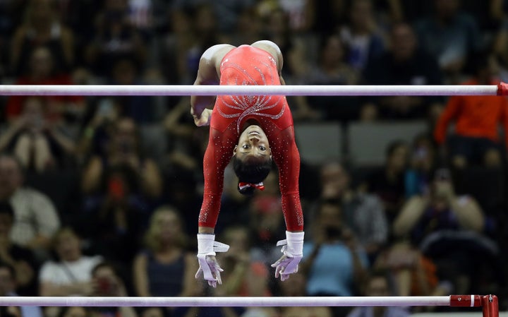 Simone Biles flies from the low bar to the high bar while competing in the U.S. Olympic Trials this June.