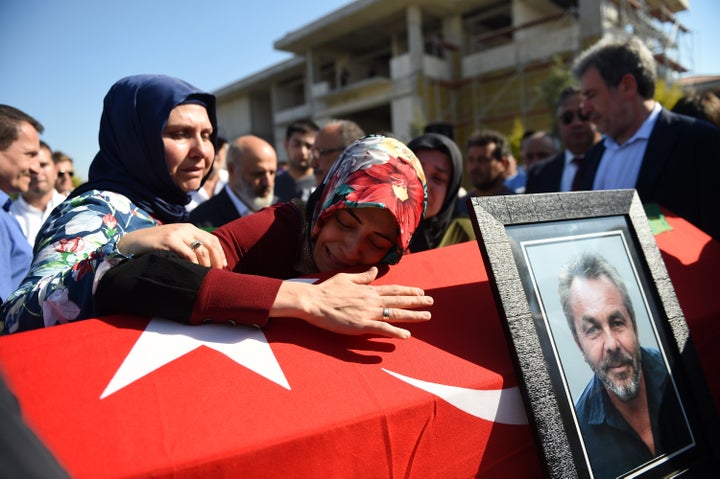 A woman mourns over a coffin on July 17 in Istanbul during the funeral for seven victims of Friday's&nbsp;coup attempt. Turki