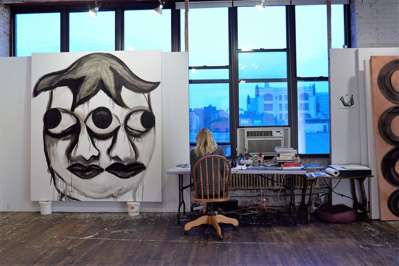 Becky drawing in the studio with <i>Multifaceted Head from Tlatilco, Mexico</i>, 2016, oil on canvas, 90 x 80 inches. 