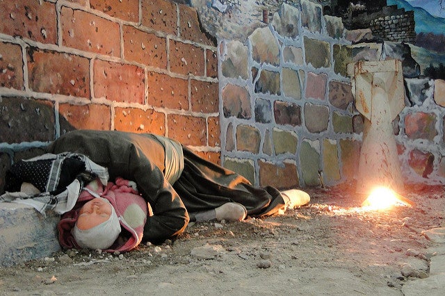 Diorama of Omer Khawar, a victim of the Halabja chemical attack, cradling a child