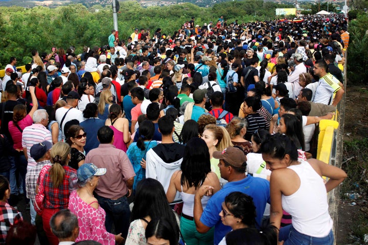 People cross over the Simon Bolivar international bridge to Colombia to take advantage of the temporary border opening.