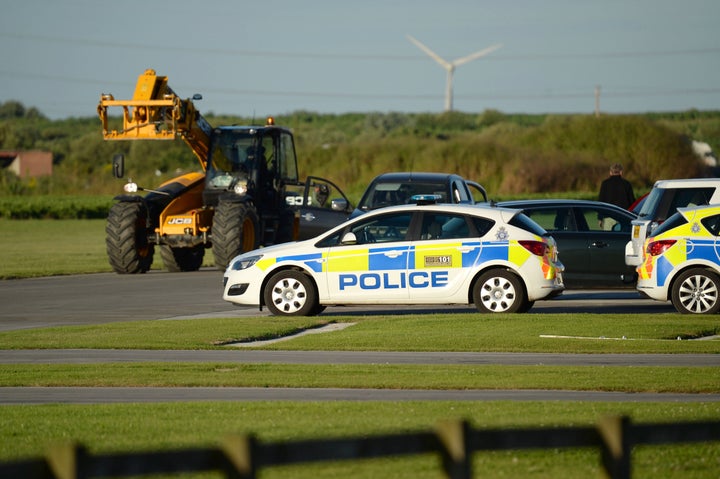 Police at the scene at Breighton airport near Selby, north Yorkshire, where five people have been seriously hurt in a helicopter crash at the aerodrome.