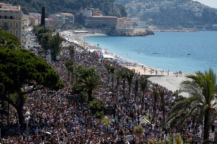 A general view shows the crowd gathering on the Promenade des Anglais during a minute of silence on the third day of national mourning.