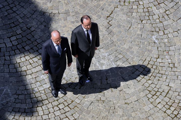 French President Francois Hollande (R) and French Interior Minister Bernard Cazeneuve (L) attended the ceremony, during which many mourners called for Hollande to resign.