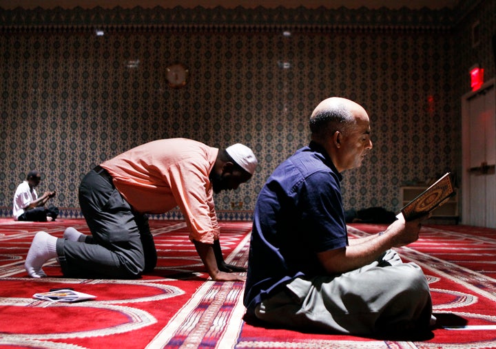 A man reads the Koran in a prayer hall at the Islamic Cultural Center of New York in the Manhattan borough of New York August 26, 2010.