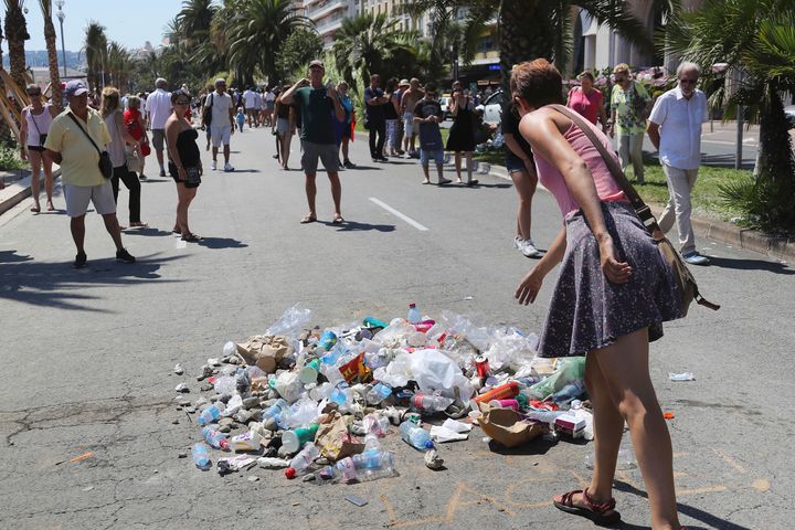 People throw garbage at the site where Mohamed Lahouaiej Bouhlel was killed by the police.