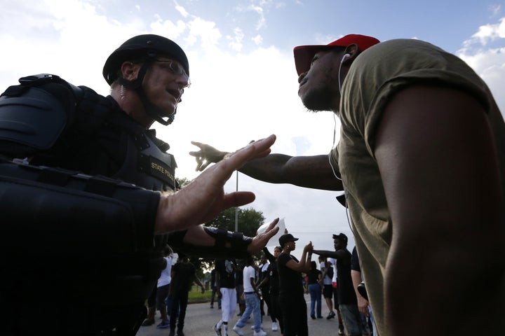 A man protesting the shooting death of Alton Sterling argues with law enforcement near the headquarters of the Baton Rouge Police Department in Baton Rouge, Louisiana. 