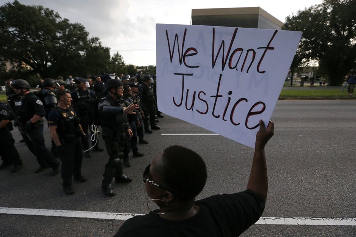 Demonstrators protest the shooting death of Alton Sterling near the headquarters of the Baton Rouge Police Department. 