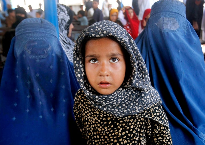 Afghan refugees wait for their documents in order to go back to Afghanistan at the UNHCR's Repatriation Center in Peshawar, P