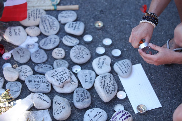 People gather and lay tributes on the Promenade des Anglais on July 17 in Nice, France.