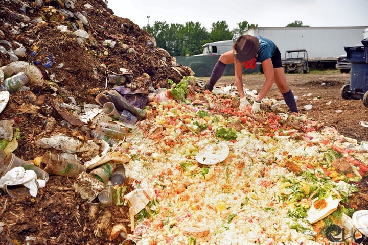 A Clean Vibes volunteer works to sort a compost pile at Bonnaroo Music Festival in Tennessee in June 2016.