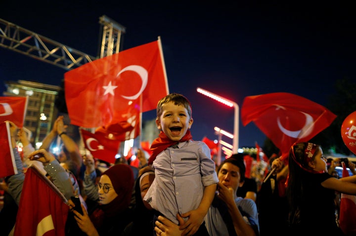 Supporters of Turkish President Tayyip Erdogan attend a pro-government demonstration at Taksim square in Istanbul on July 17,