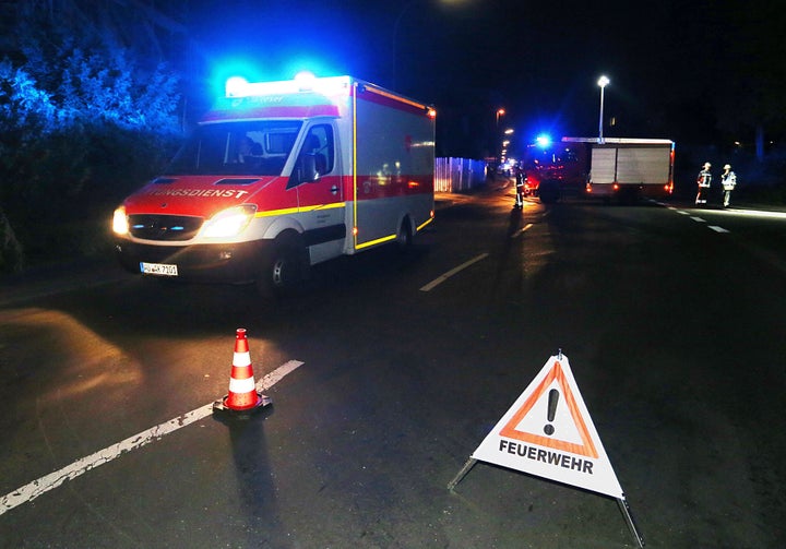 Rescuers gather on a road near railtracks in Wuerzburg, southern Germany, after a man attacked train passengers with an axe