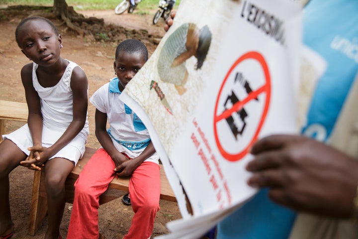 Girls attend a community meeting on FGM, in the northern town of Katiola in Côte d'Ivoire. The meeting was organized by the NGO OIS Afrique, which works with communities and FGM/C practitioners to end the harmful traditional practice.