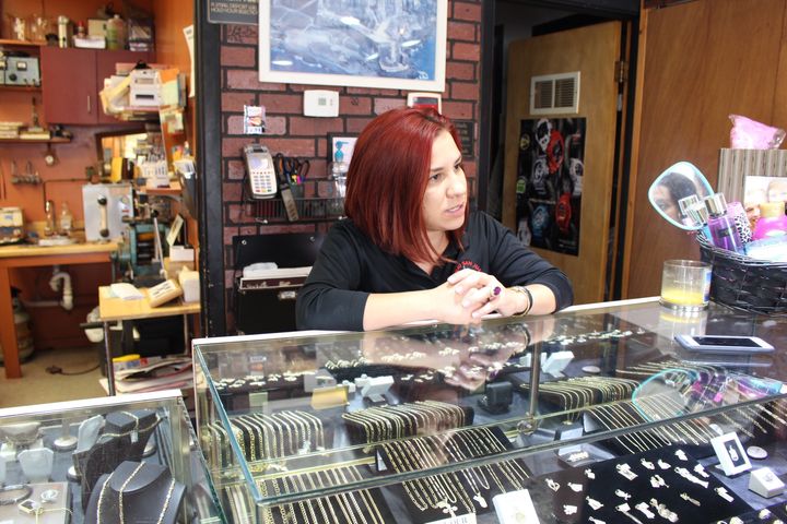 Alejandra Pagan, 28, stands at the counter of the family-run Viejo San Juan jewelry store in Cleveland's heavily Hispanic West side. She disagrees with the hardline immigration positions espoused by the RNC and the Republican presidential nominee Donald Trump.