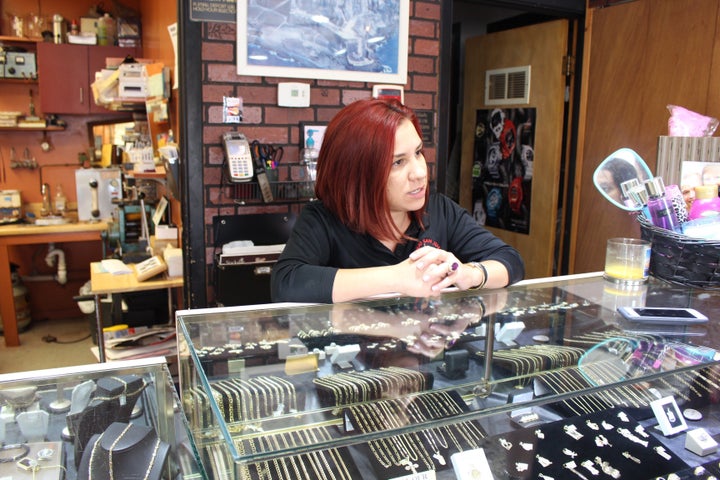 Alejandra Pagan, 28, stands at the counter of the family-run Viejo San Juan jewelry store in Cleveland's heavily Hispanic Wes
