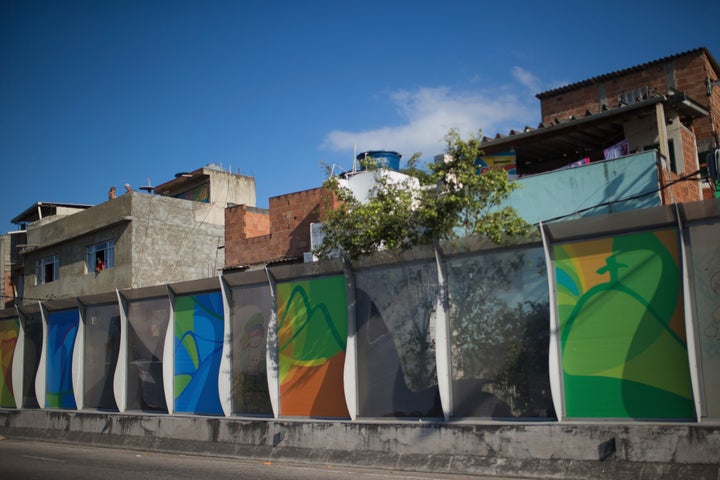 A banner advertising the 2016 Rio Olympics is seen near the Mare slums complex of the Linha Vermelha freeway.