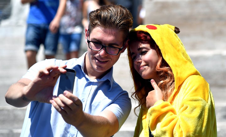 Gamers use the Pokemon Go application on their mobiles in central Rome on July 19, 2016.