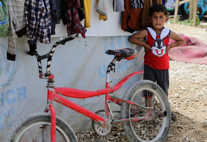 A Syrian refugee boy plays at an unofficial refugee camp in Lebanon's town of Bar Elias in the Bekaa Valley on May 13, 2016. Five years into the Syria conflict, Lebanon hosts more than one million refugees from the war-torn country, according to the United Nations. More than a third live in the Bekaa valley near the Syrian border. As towns there strive to accommodate tens of thousands of Syrian arrivals, some local councils are struggling to provide them with burial services because town cemeteries are almost full. / AFP / JOSEPH EID / TO GO WITH AFP STORY BY ALICE HACKMAN