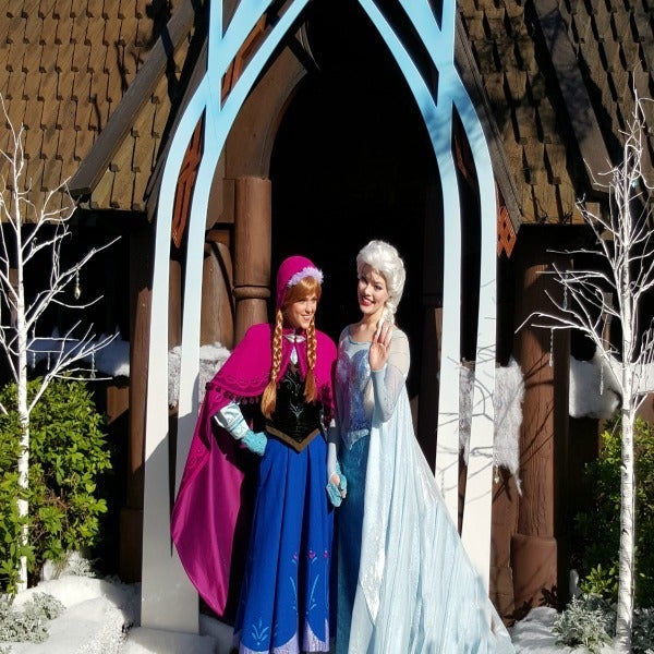 Anna and Queen Elsa greet fans during the opening ceremony for Frozen Ever After.