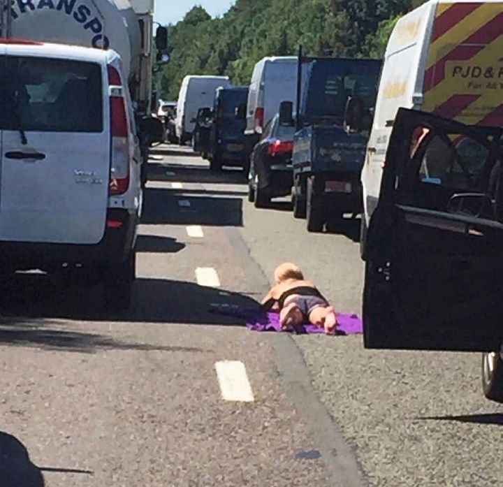 A woman catches some rays during a traffic incident yesterday