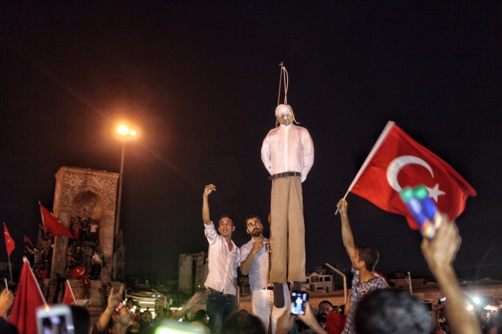 Erdogan supporters hold an effigy of the Fethullah Gulen during a pro-government demonstration in Istanbul's central Taksim Square on Tuesday. Turkey is preparing a formal request to the U.S. for the extradition of the cleric.