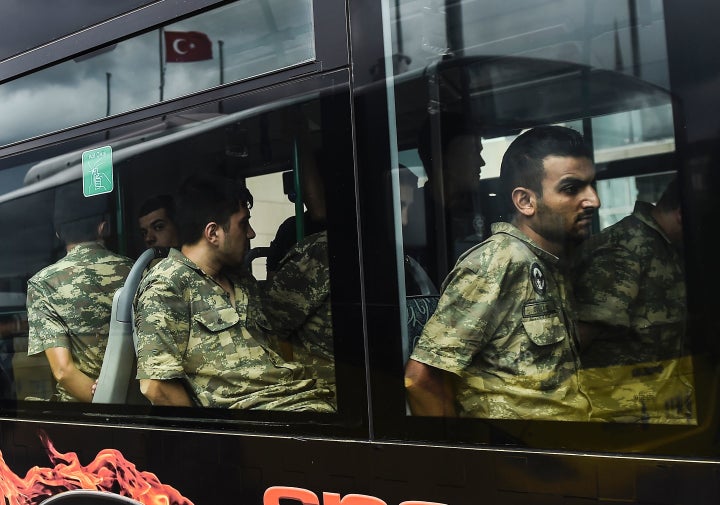 Detained Turkish soldiers arrive in a bus at the courthouse in Istanbul on Tuesday, who accused of taking part in a military coup against the Turkish government.