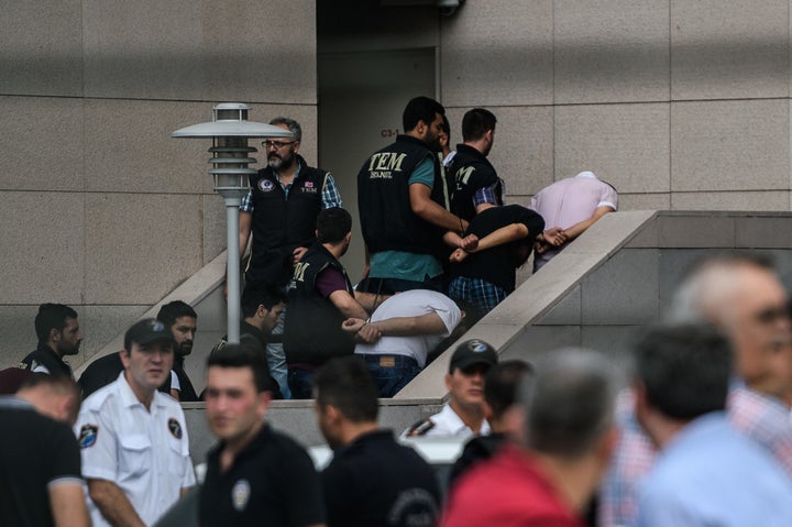 Detained Turkish soldiers who allegedly took part in a military coup arrive with their hands bound behind their backs at the Istanbul Justice Palace.