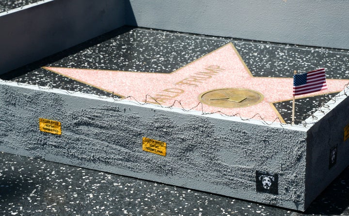 LA-based street artist Plastic Jesus erected a 6-inch concrete wall around Donald Trump's Hollywood Walk of Fame star on 