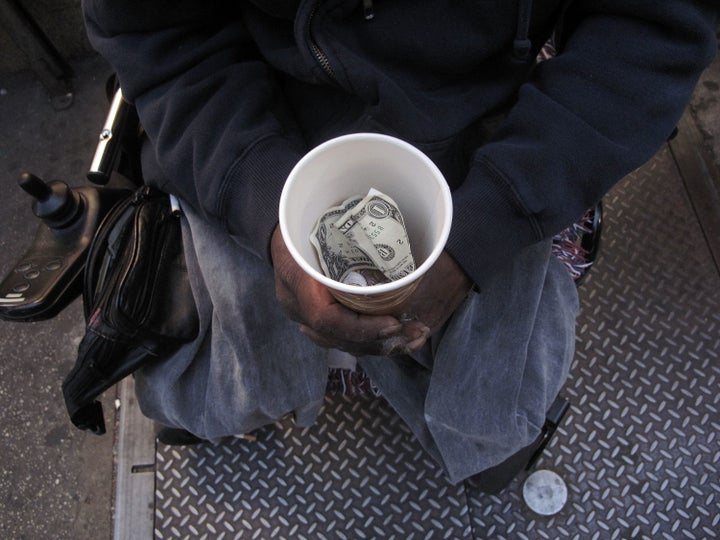 NEW YORK - OCTOBER 23: A homeless man who goes by the name Cleveland displays a cup containing money from panhandling on Octo