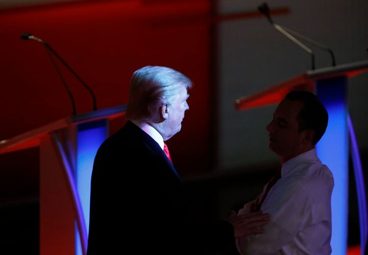 Donald Trump deals with Reince Priebus during a commercial break at one of the primary debates. 