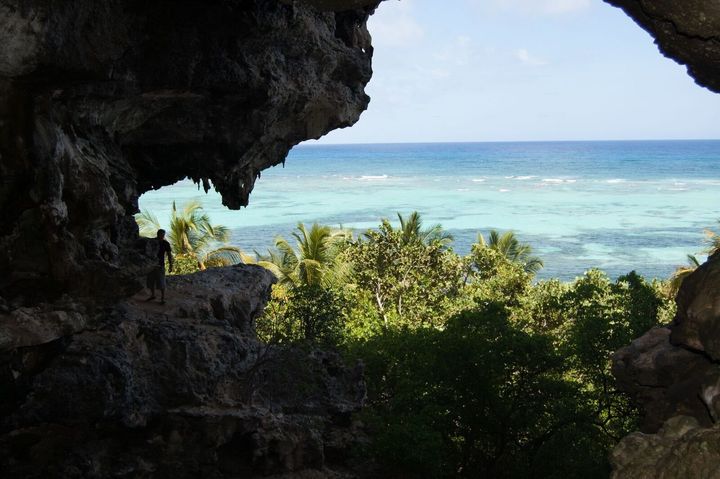 Some of the caves are much harder to access than others. The view from one overlooking the water is seen.