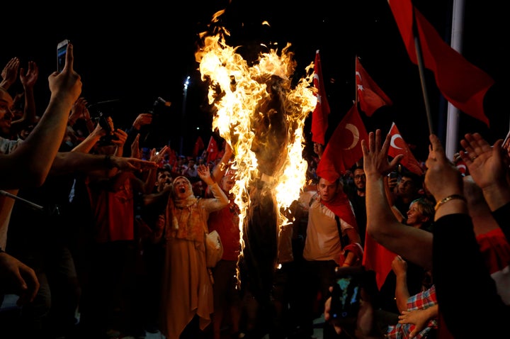 Erdogan supporters burn an effigy of Fethullah Gulen during a pro-government demonstration at Taksim Square in Istanbul