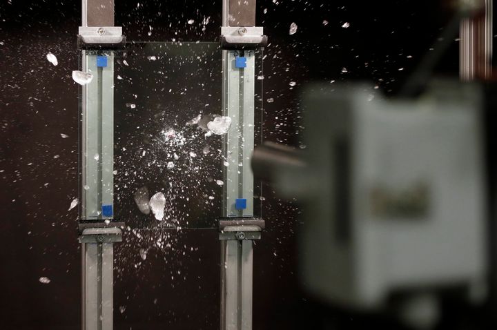 In a photo from Dec. 14, 2015, an ice ball breaks up after hitting a sample of Corning Inc.'s Gorilla Glass at the Dearborn Development Center in Dearborn, Michigan.
