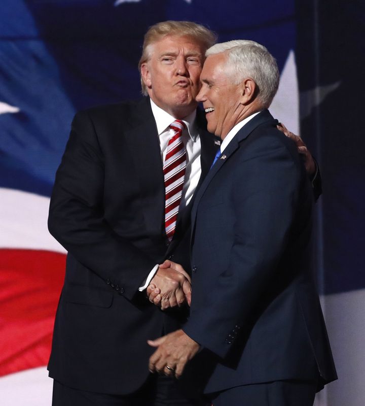 Republican U.S. presidential nominee Donald Trump (L) greets vice presidential nominee Mike Pence after Pence spoke during the third day of the Republican National Convention in Cleveland, Ohio, U.S. July 20, 2016.