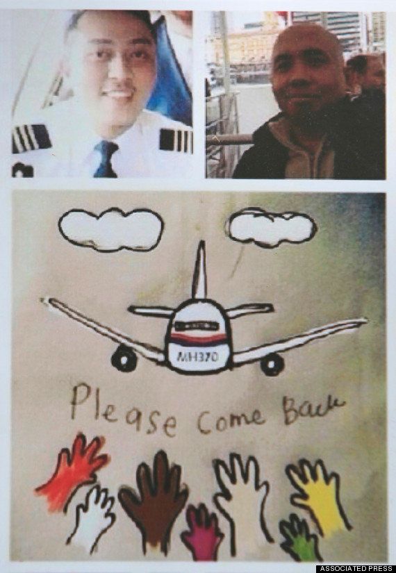 <strong>A photo of Zaharie Shah (top right) and co-pilot Fariq Abdul Hamid (top left) atop a poster appealing for the missing plane to ‘please come back’</strong>