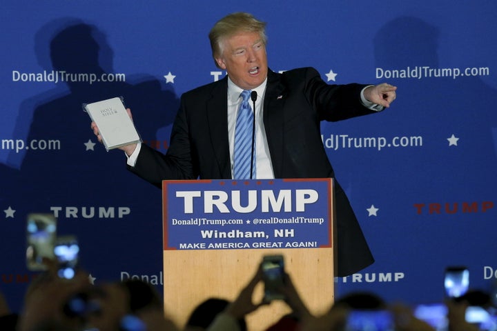 U.S. Republican presidential candidate Donald Trump holds a Bible given to him by an audience member at a campaign rally.