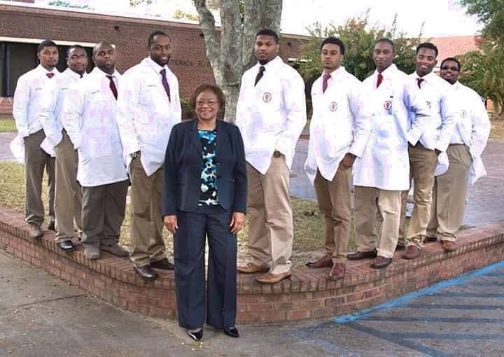 TUCVM dean Dr. Ruby Perry poses with the next generation of future Tuskegee-trained veterinarians.