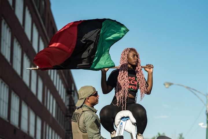 A Chicago demonstrator flies the Pan-African flag at a protest aimed at reining in police unions on Wednesday.