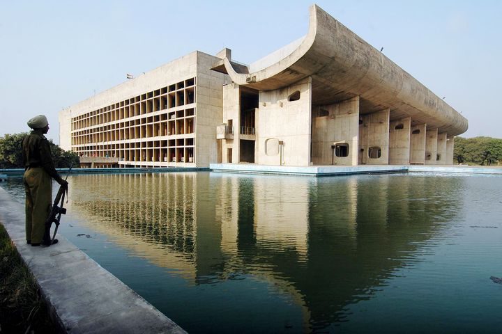 A guard stands beside the Assembly Building in Chandigarh, the Indian city planned by Le Corbusier in the 1950s.